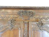 a close up of a wooden armoire with carvings on it