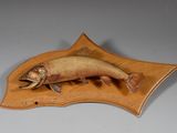 un poisson posé sur une plaque en bois