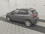 a grey car parked in a garage with a black and white checkered floor