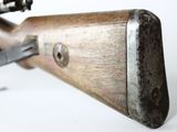 an old rifle with a wooden barrel and a metal handle