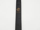 a close up of a black tie with a gold logo on it