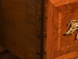 a wooden chest of drawers with a horse design on it
