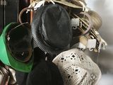 many hats hanging on a rack in a room