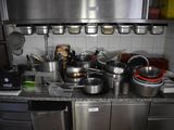 many pots and pans on the counter in the kitchen