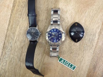 a watch that is laying on a table next to a key