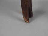 a small wooden elephant that is standing on a table