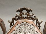 a large metal vase with a decorative design on it