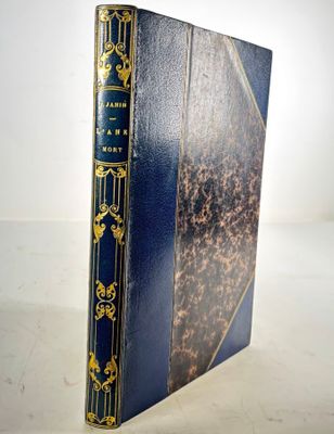 an old book sitting on top of a white table next to a white wall