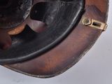 a close up view of a hat with a leather band
