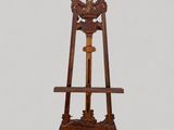 a wooden easel with a clock on top of it