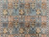 a blue and beige rug with a floral design on it