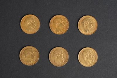 six different types of gold coins on a black surface