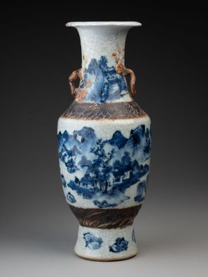 a blue and white vase sitting on a table