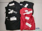 three men ' s shirts with price tags on them sitting on a table