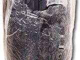 a car tire wrapped in plastic on a white background