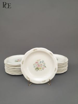 six assiettes blanches ornées de motifs floraux sont empilées les unes sur les autres
