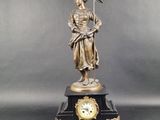 an image of a statue of a woman holding a clock