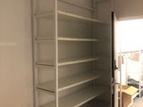 a room with shelves and a table in it