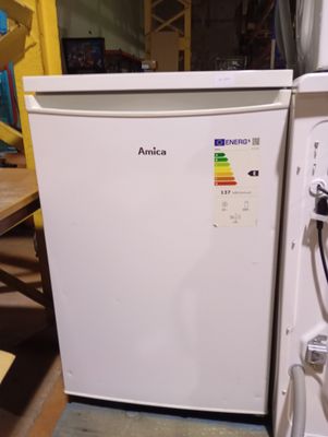 an image of a white refrigerator in a warehouse