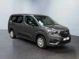 the grey van is parked in a room with a black floor