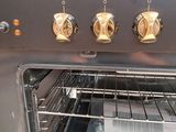 a silver oven with four burners and four knobs