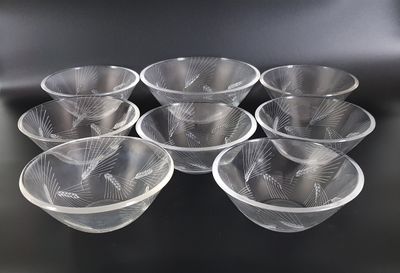 six clear plastic bowls sitting on top of a black table