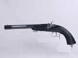 a gun that is sitting on top of a clear stand