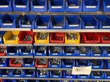 many bins of different types of screws on the shelf
