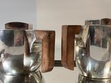 two silver cups on a silver tray on a table