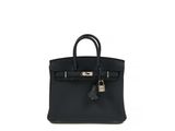 a black leather handbag on a white background