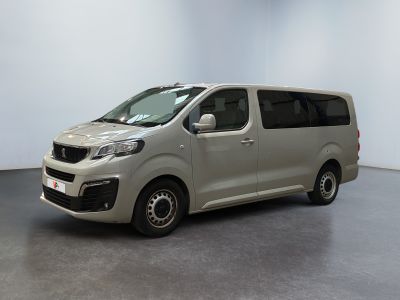 the silver van is parked in a room with a white wall