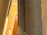 a cat that is peeking out of a door