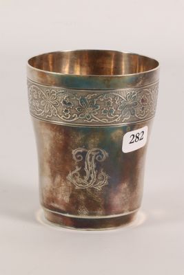 an antique silver cup with a monogram on the side