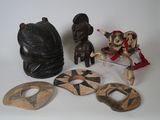several pieces of african art are displayed on a white surface