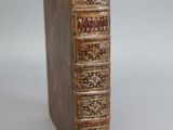 an old book sitting on top of a table next to a white background