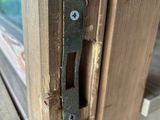 a close up of a door handle on a wooden door