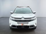 the front view of a white citrole parked in a white room