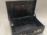 a black suitcase that is open on a white surface