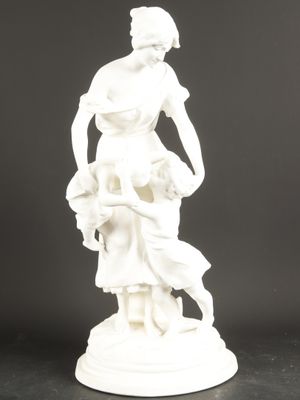 a white statue of a woman holding a basket of flowers