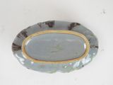 a blue plate with a yellow rim on a white table