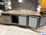 a kitchen with a counter and a refrigerator in it