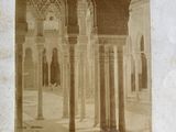 an old photo of a building with columns and arches