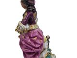 an image of a figurine of a woman sitting on a bench