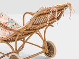 an image of a wicker baby carriage with a floral seat