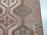 an old rug with a design on it on a white floor