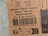 a person holding a brown ticket with a barcode on it