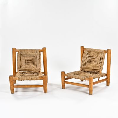 pair of mid - century chairs with woven seats and wooden frame