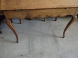 a wooden table with a drawer on top of it