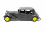a black toy car with yellow wheels on a white surface