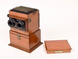 a small wooden box with a camera on top